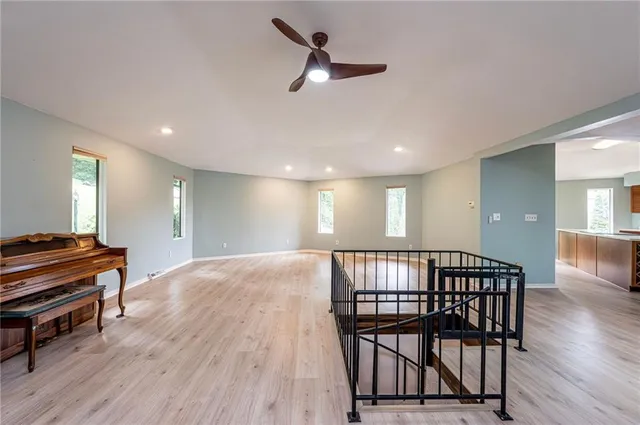 a view of a hallway with workspace and wooden floor