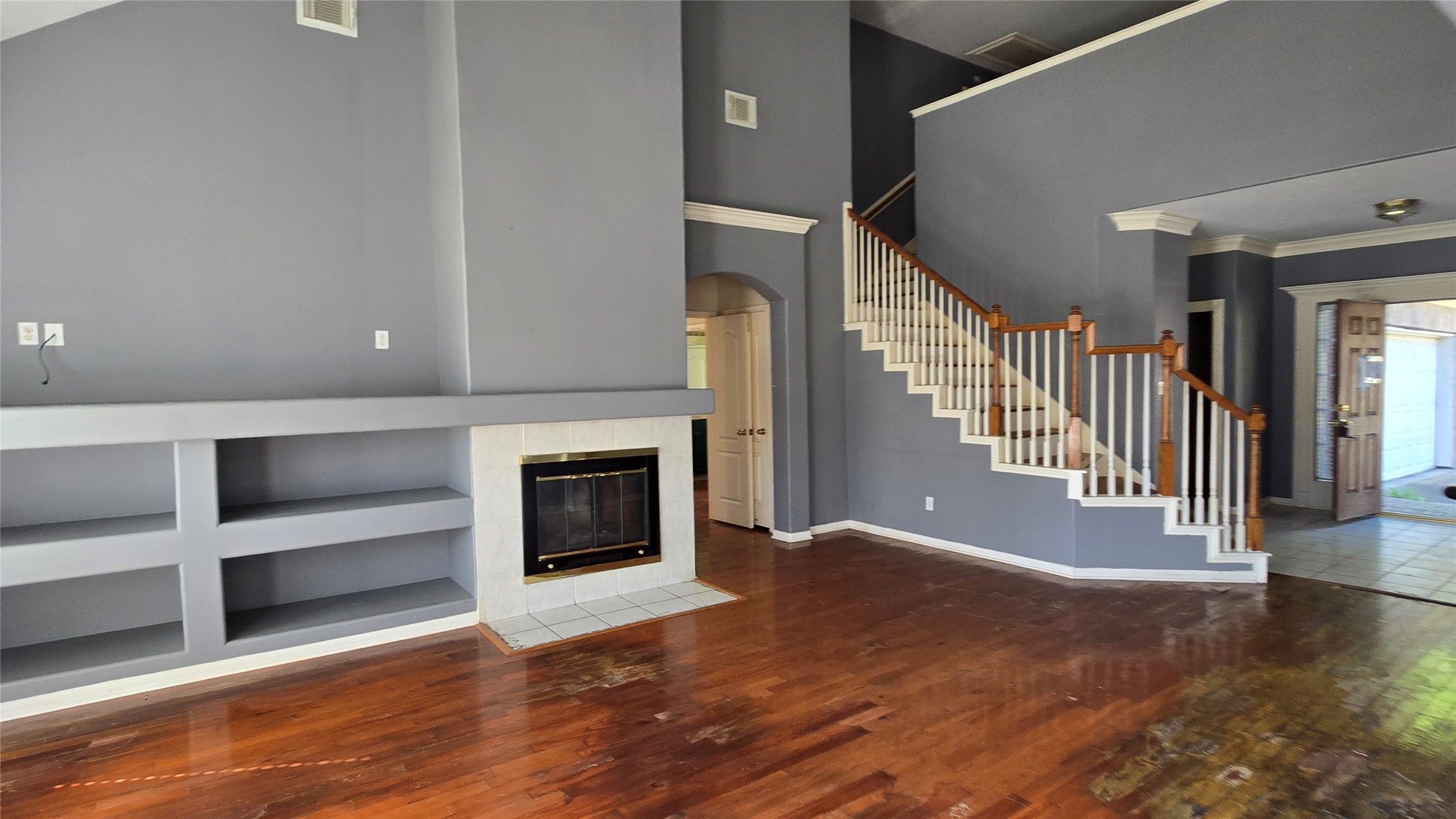 131 Annes Way Stafford, TX 77477 - Photo 9 of 25 a view of an empty room with stairs and a fireplace