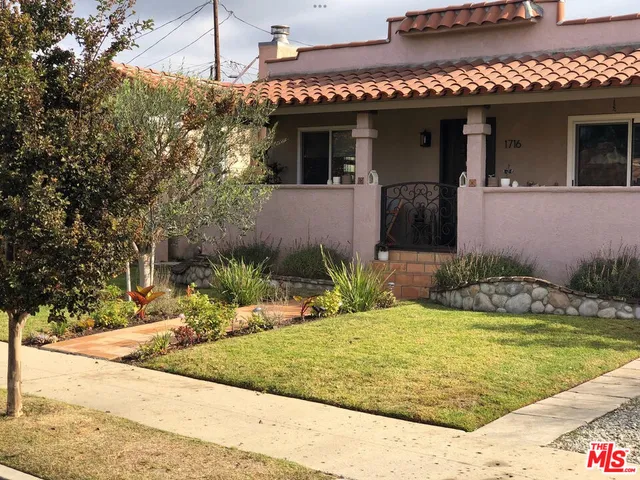 a view of a house with potted plants
