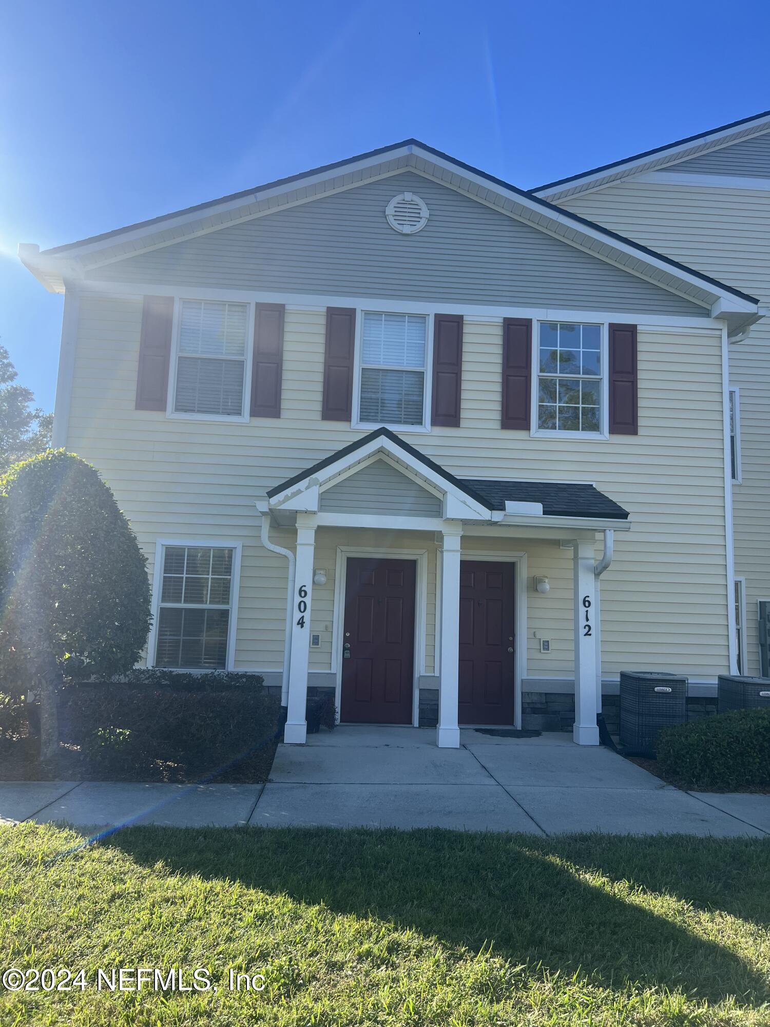 2200 Marsh Hawk Lane, Unit 604 Fleming Island, FL 32003 - Photo 1 of 19 a front view of a house with a yard