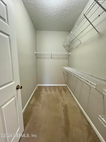 a view of storage and utility room with racks on the wall
