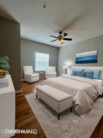 a spacious bedroom with a bed and a chandelier