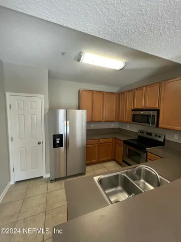a kitchen with a sink cabinets and stainless steel appliances