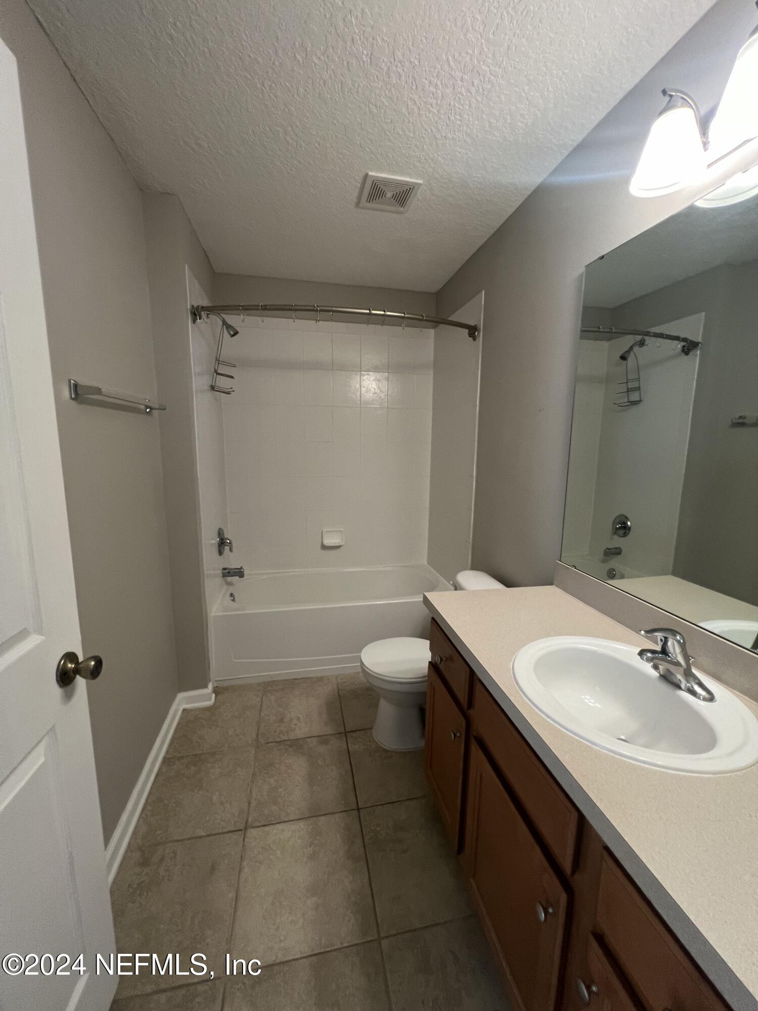 2200 Marsh Hawk Lane, Unit 604 Fleming Island, FL 32003 - Photo 10 of 19 a bathroom with a sink a toilet and shower