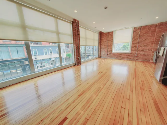 a view of an entryway with wooden floor
