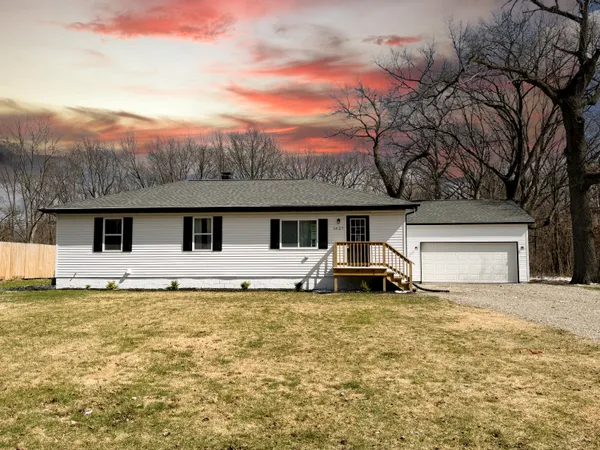 a front view of house with yard and seating area