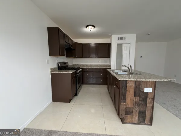a kitchen with stainless steel appliances granite countertop a sink counter space and cabinets