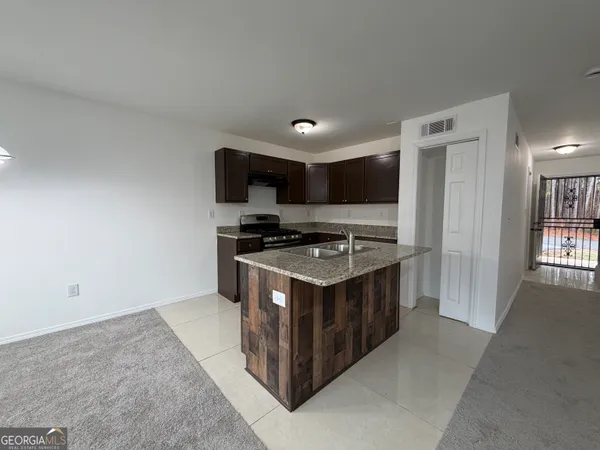 a kitchen with stainless steel appliances granite countertop a stove and a refrigerator