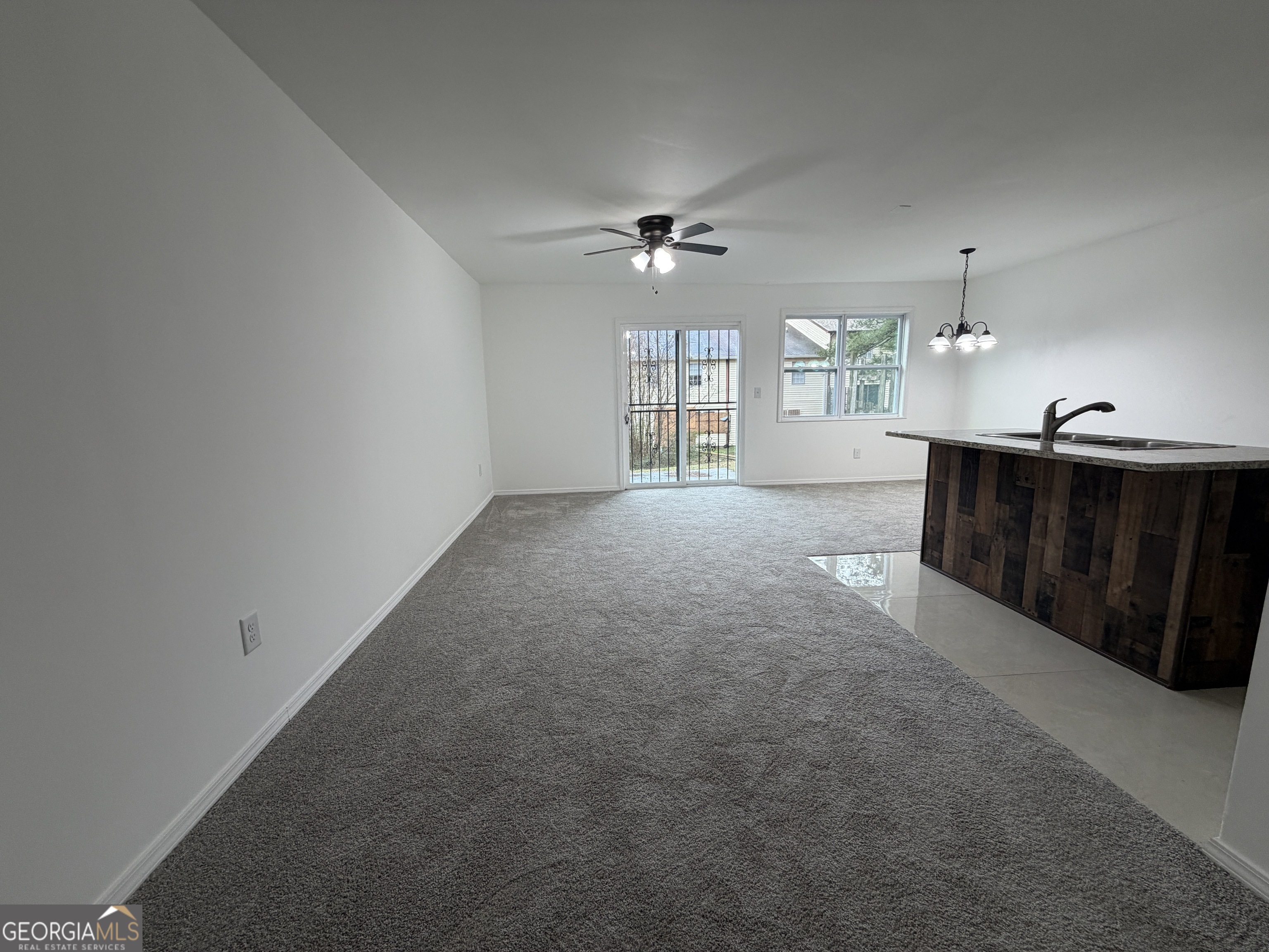 2113 Pine Tree Trail South Fulton, GA 30349 - Photo 13 of 49 en empty room with windows and ceiling fan