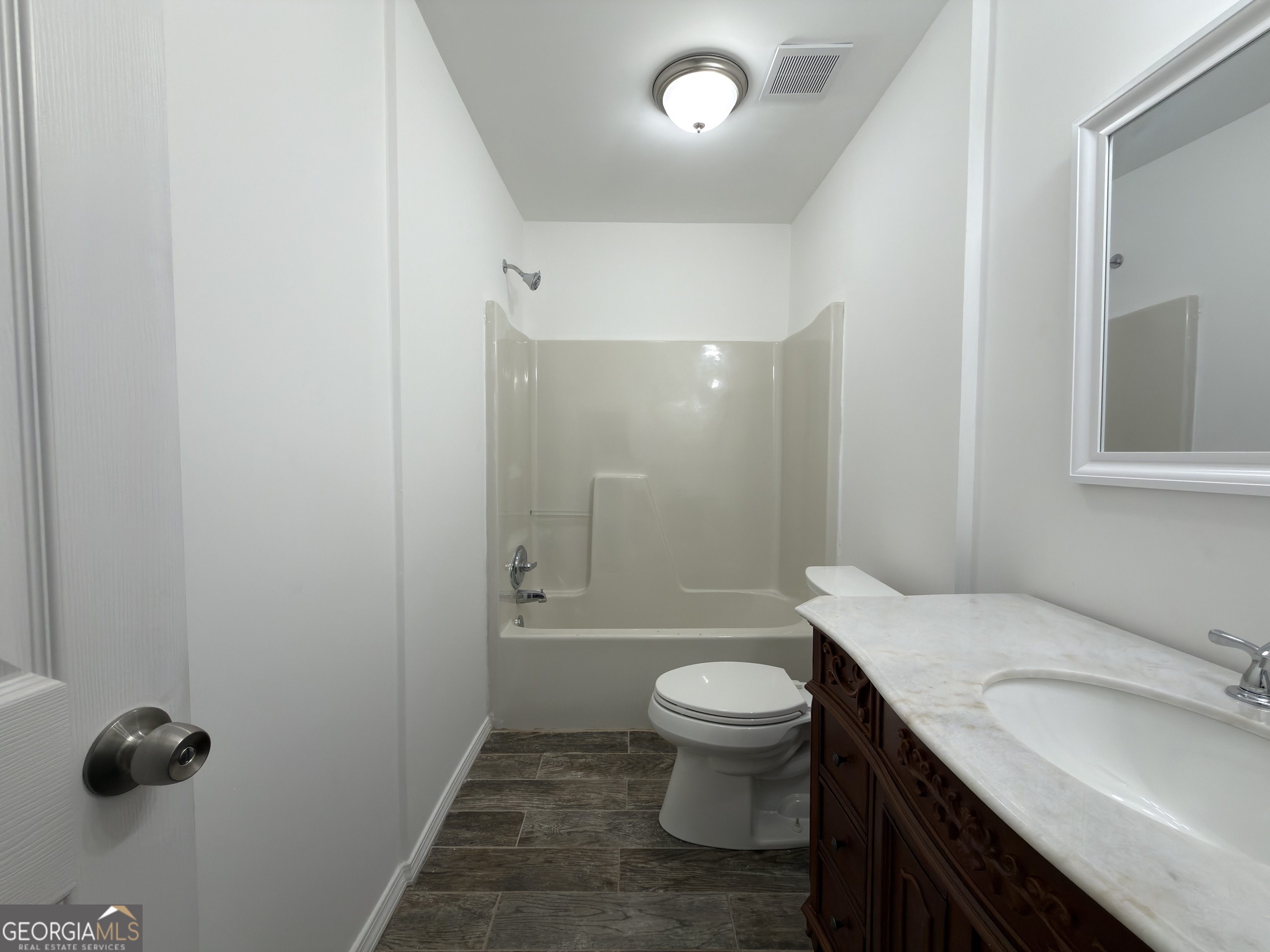 2113 Pine Tree Trail South Fulton, GA 30349 - Photo 21 of 49 a bathroom with a granite countertop sink toilet a mirror and shower