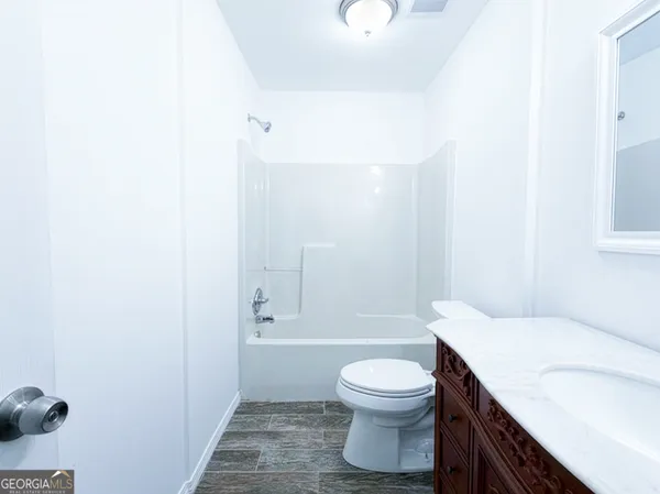 a bathroom with a mirror and a shower