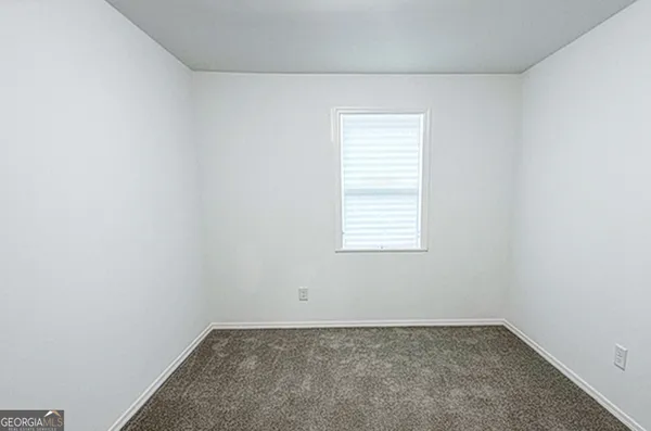 a bathroom with a sink toilet and a mirror