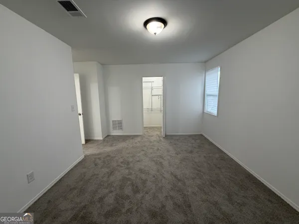 a bathroom with a granite countertop sink a toilet and a mirror