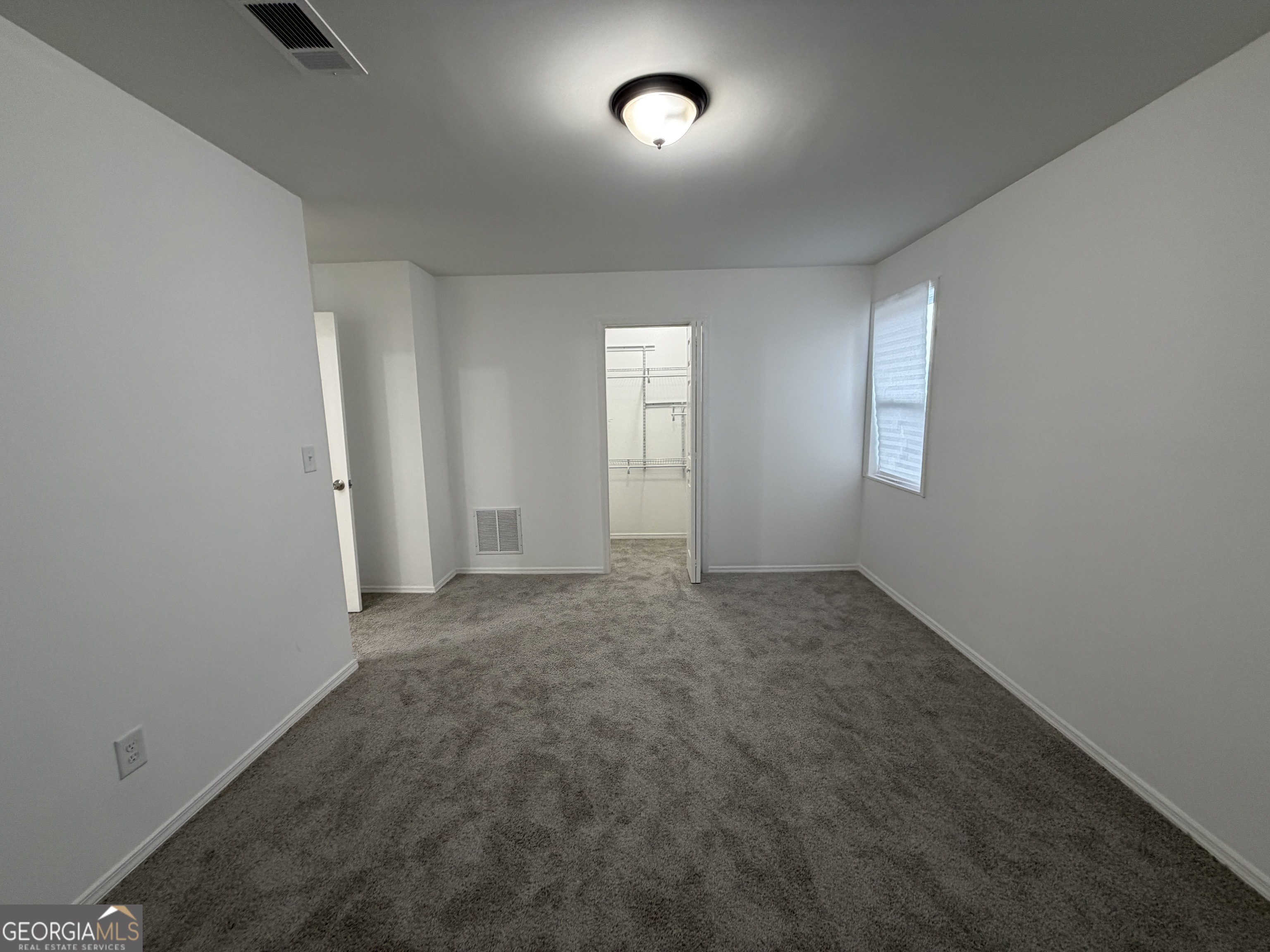 2113 Pine Tree Trail South Fulton, GA 30349 - Photo 28 of 49 an empty room with windows and closet