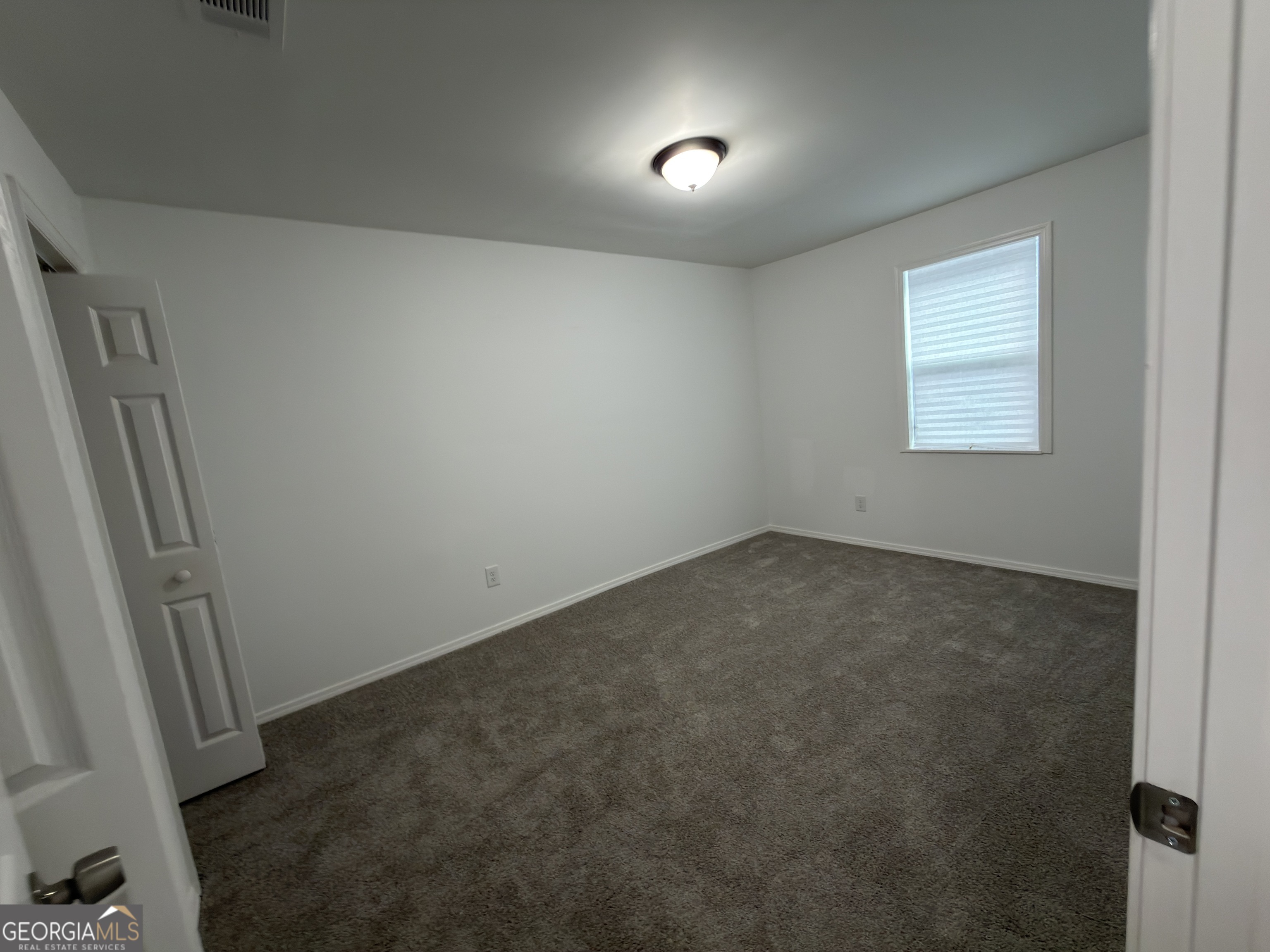 2113 Pine Tree Trail South Fulton, GA 30349 - Photo 33 of 49 an empty room with a window