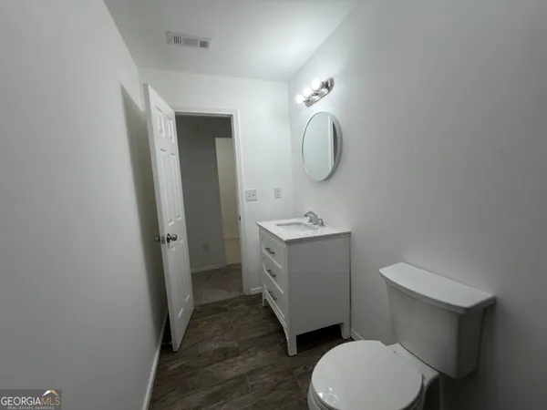 a white toilet sitting next to a bathroom sink