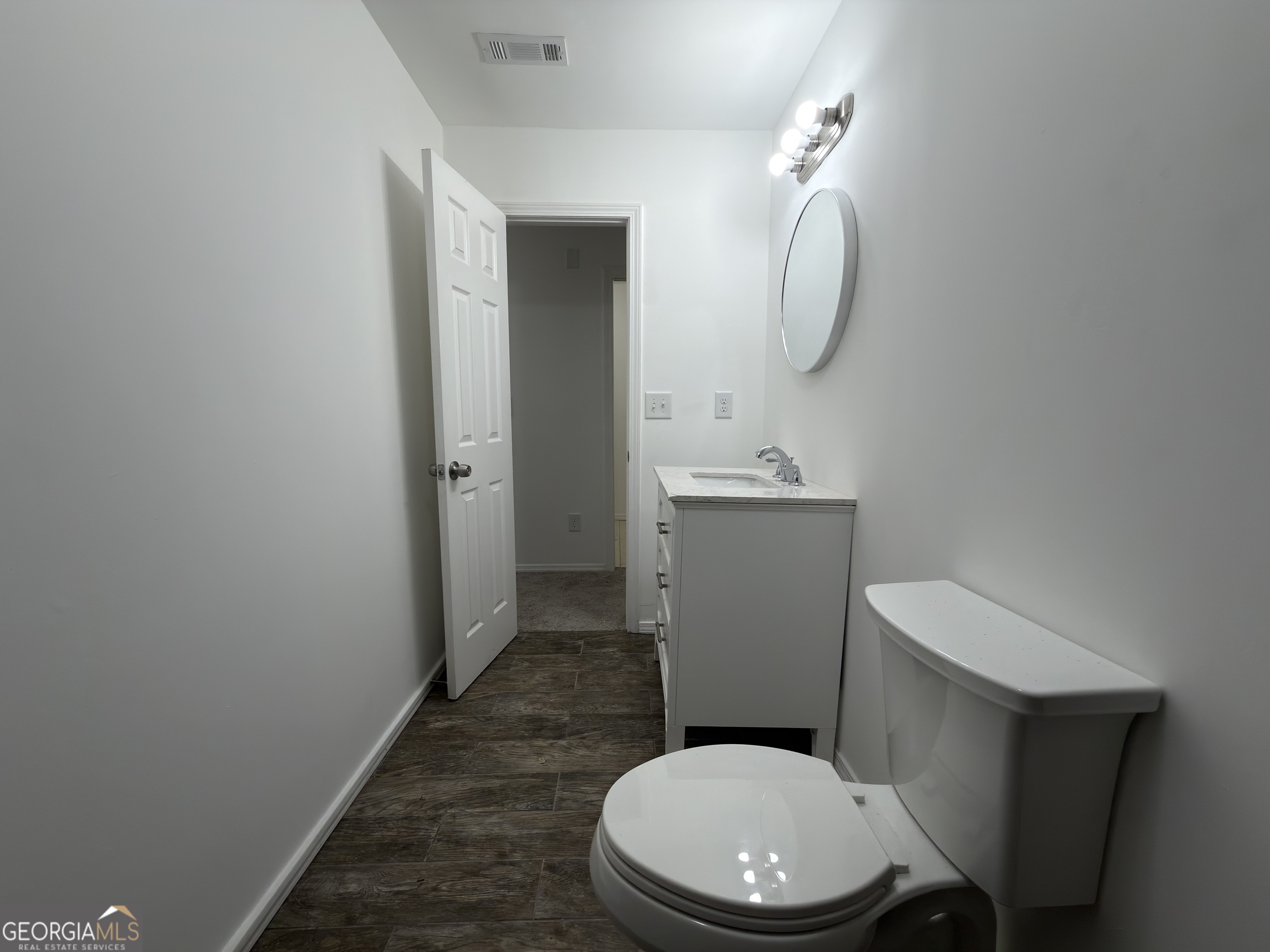 2113 Pine Tree Trail South Fulton, GA 30349 - Photo 43 of 49 a white toilet sitting next to a bathroom sink