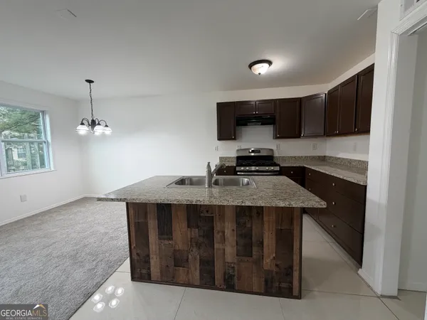 a kitchen with a stove and a sink