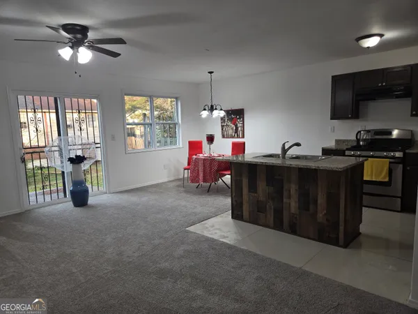 a living room with furniture a chandelier and a window