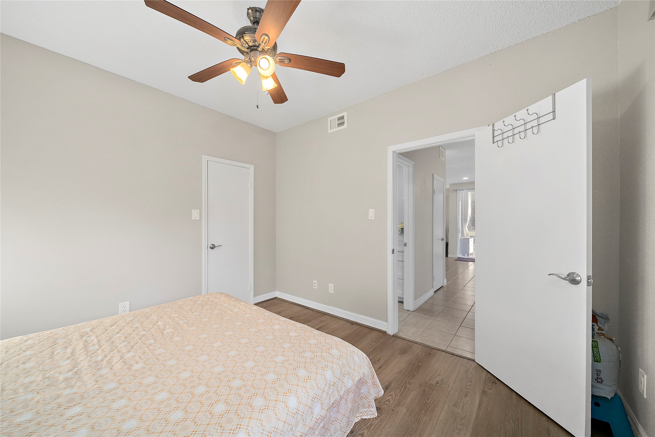 8257 Sands Point Drive, Unit 167 Houston, TX 77036 - Photo 13 of 16 a bedroom with a bed and a ceiling fan