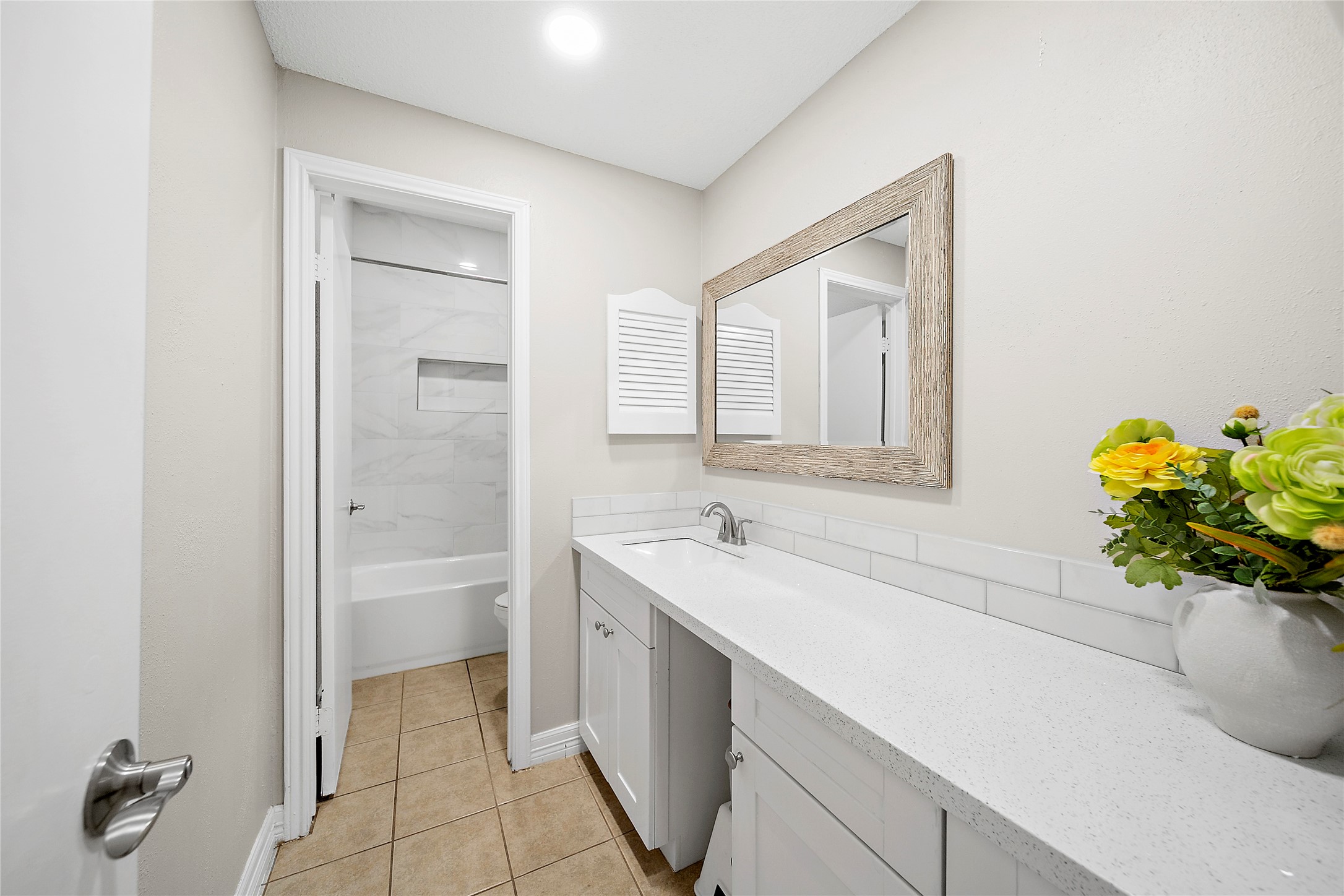 8257 Sands Point Drive, Unit 167 Houston, TX 77036 - Photo 14 of 16 a bathroom with a granite countertop sink a toilet and shower