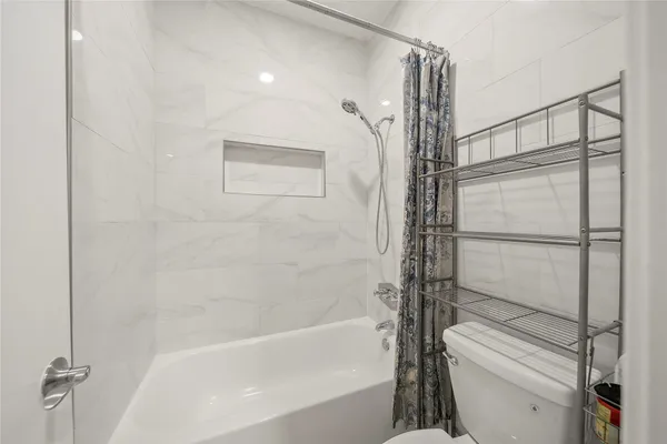 a bathroom with a bathtub and a shower