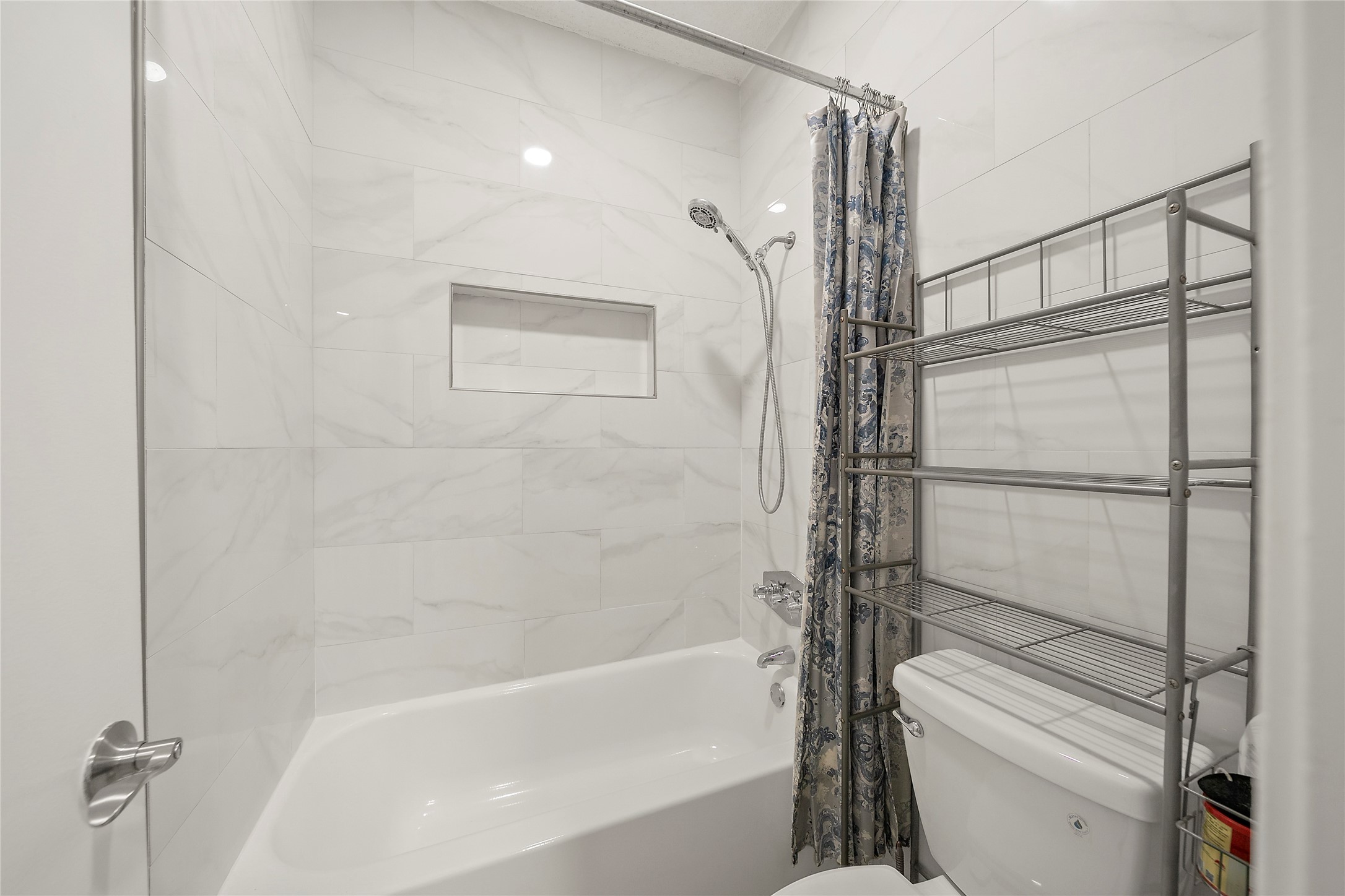 8257 Sands Point Drive, Unit 167 Houston, TX 77036 - Photo 15 of 16 a bathroom with a bathtub and a shower