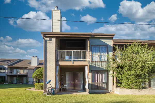 a view of a house with a yard balcony and entertaining space