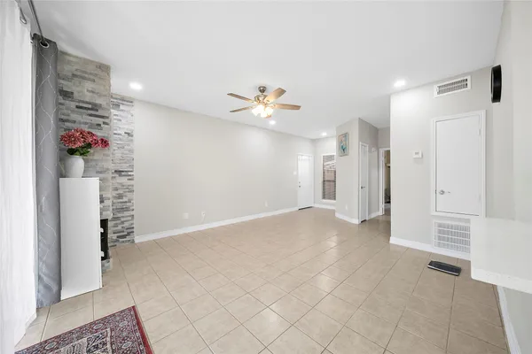 a view of an empty room with a ceiling fan