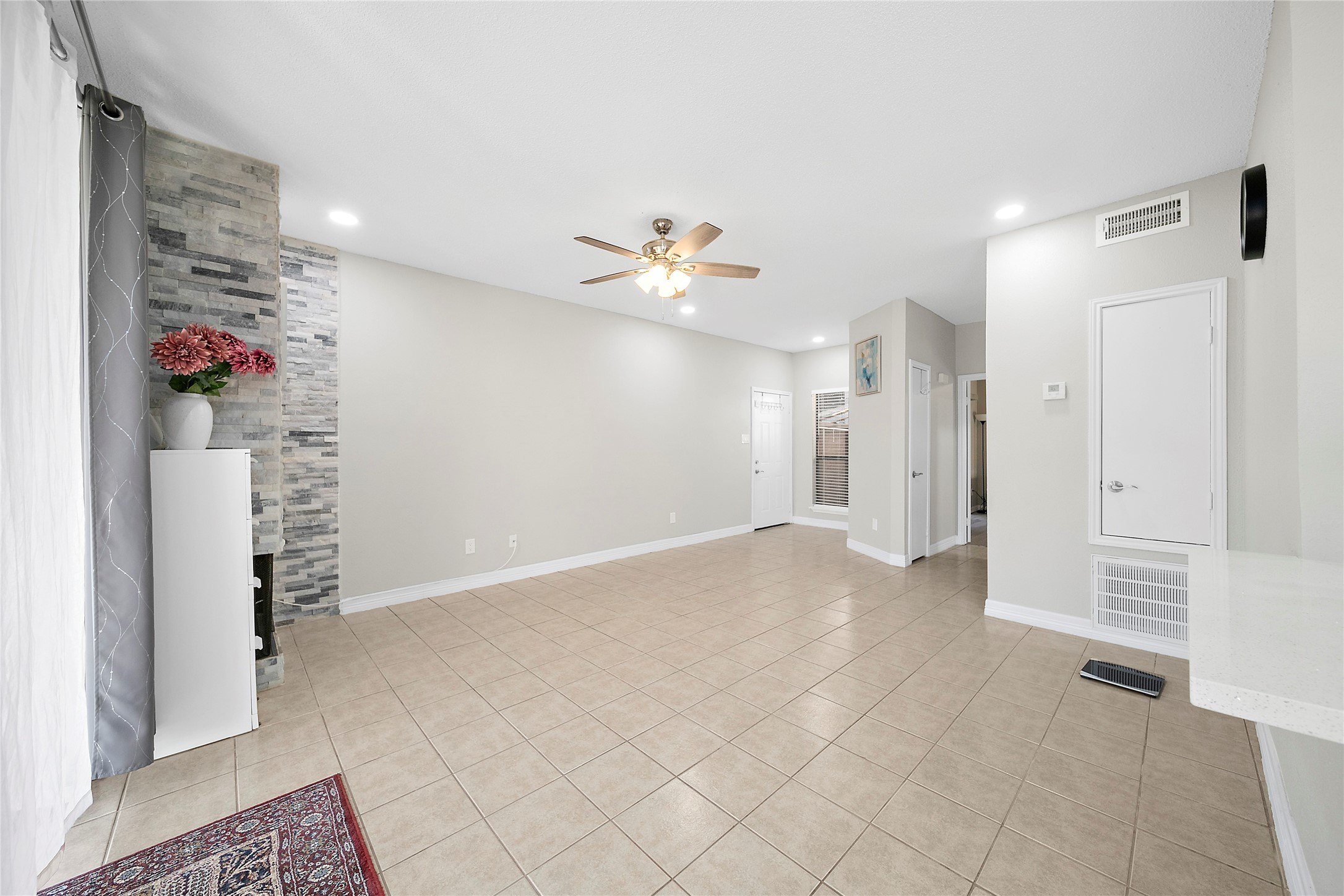 8257 Sands Point Drive, Unit 167 Houston, TX 77036 - Photo 3 of 16 a view of an empty room with a ceiling fan