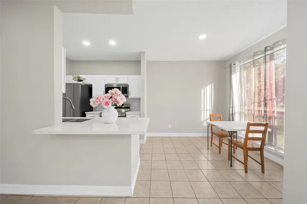 a living room with furniture and flowers