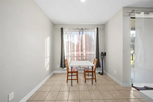 a view of a dining room with furniture and a chandelier