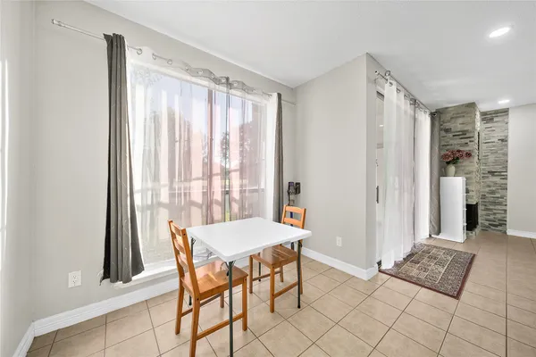 a dining room with furniture and window