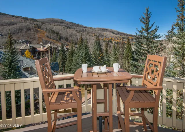 a view of city from balcony with furniture