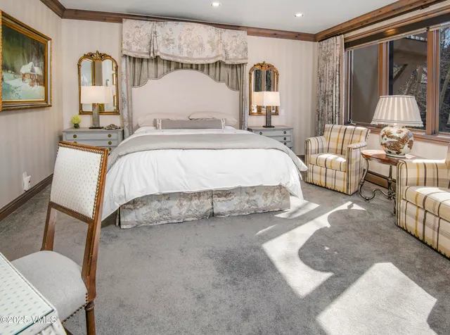 a bedroom with a bed couch and window