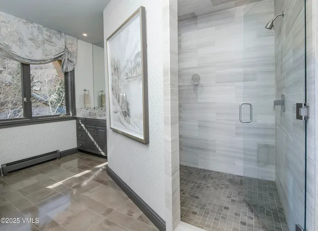 a view of a bathroom with a glass door shower