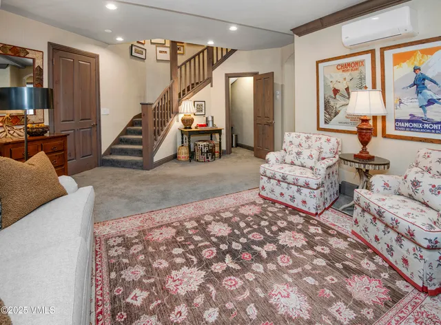 a living room with furniture and stairs