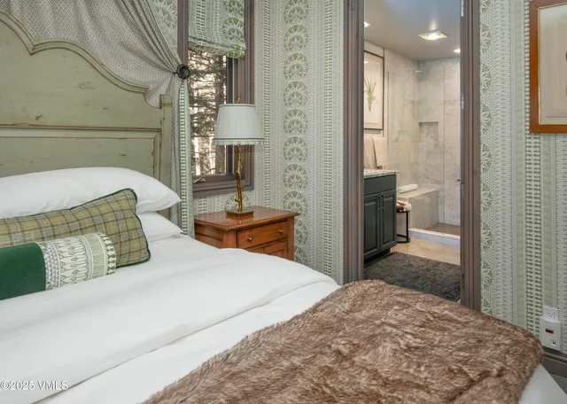 a bedroom with a bed and a view of bathroom