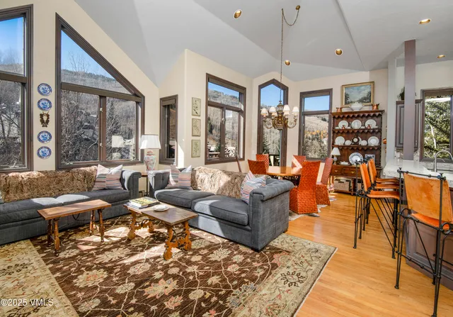 a living room with patio furniture and a large window