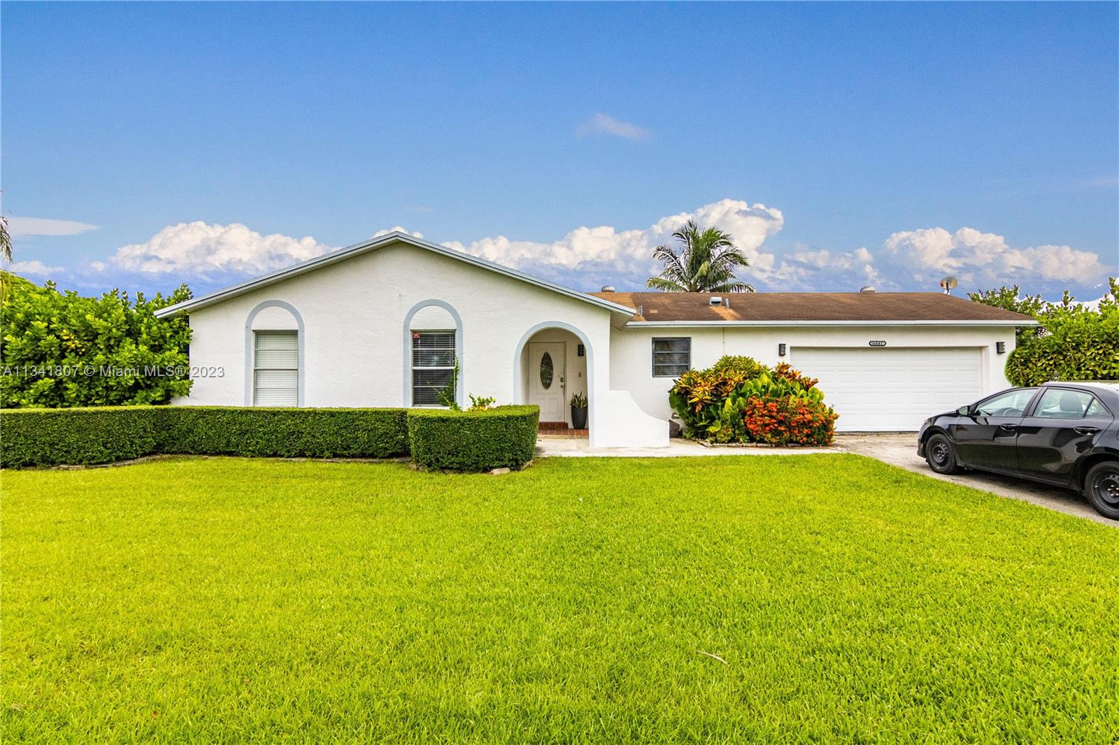 16041 Southwest 284th Street Homestead, FL 33033 - Photo 1 of 20 a view of a house with patio and garden