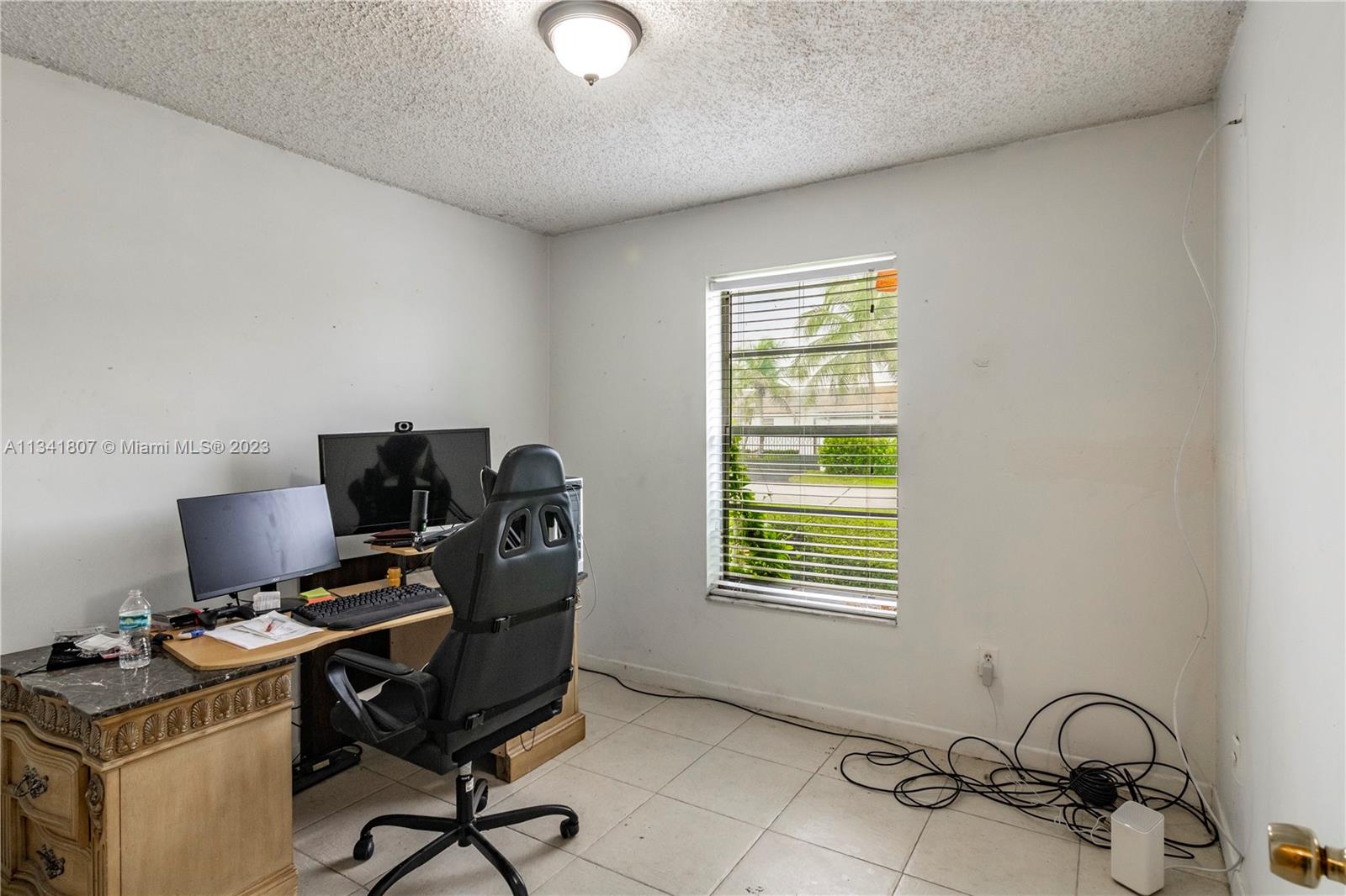 16041 Southwest 284th Street Homestead, FL 33033 - Photo 11 of 20 a view of a workspace with furniture and a window