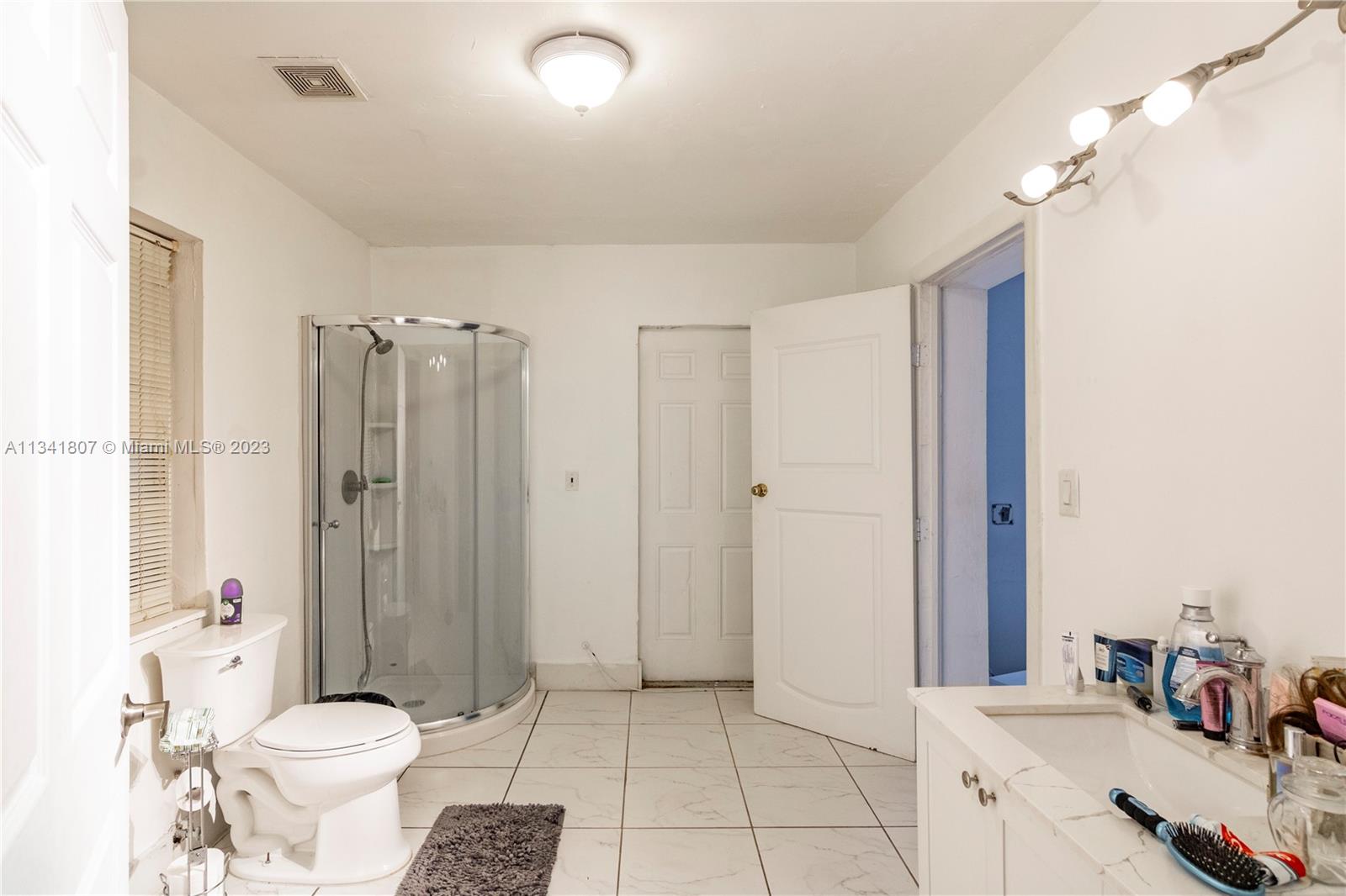 16041 Southwest 284th Street Homestead, FL 33033 - Photo 10 of 20 a bathroom with a sink toilet and shower