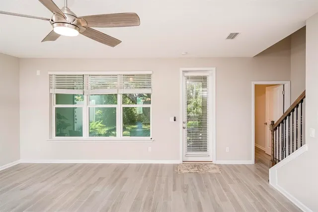 a view of a kitchen with wooden floor and electronic appliances