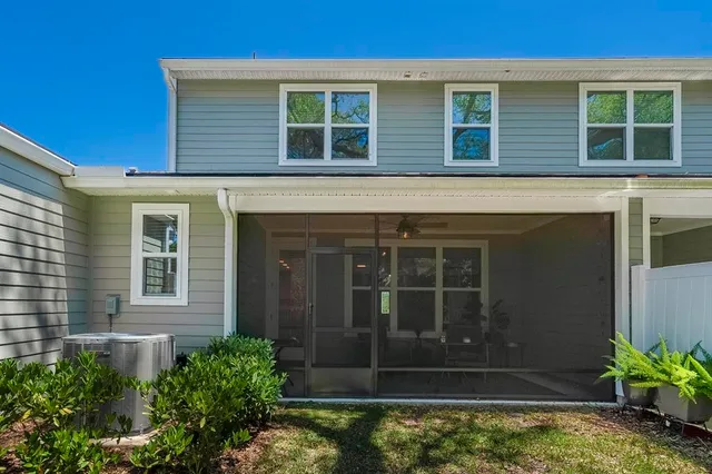 a front view of a house with swimming pool and sitting area