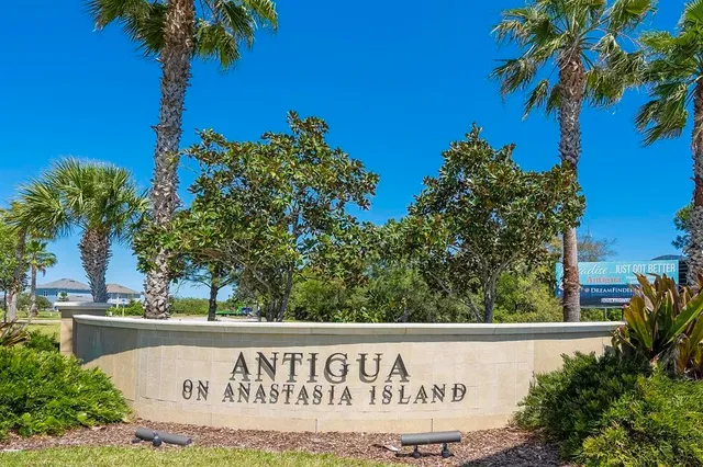 a view of a swimming pool with a lounge chair and a small yard