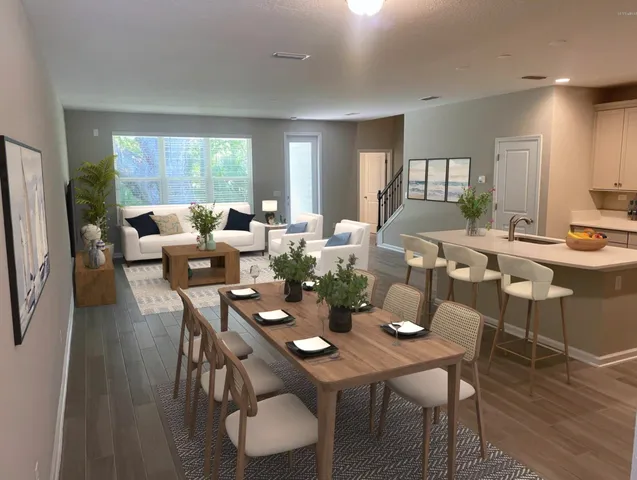 a living room with dining room and kitchen view