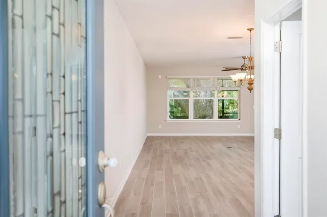 a large kitchen with kitchen island a stove a sink dishwasher a refrigerator and a dining table with wooden floor