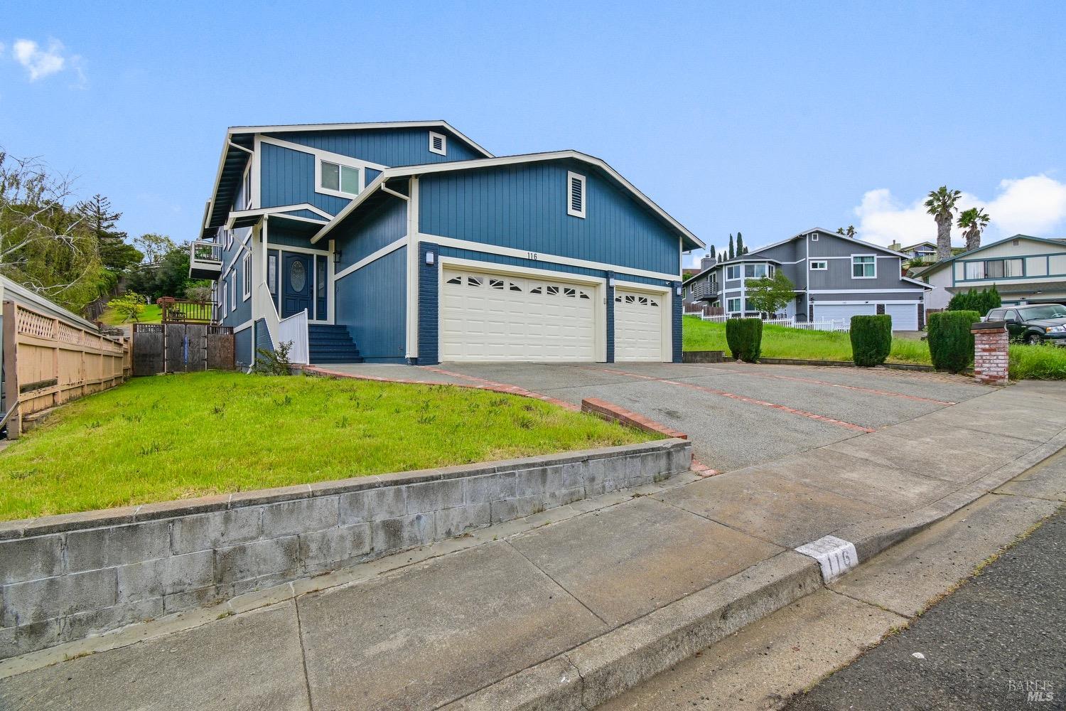 a view of a house with a big yard plants and large trees
