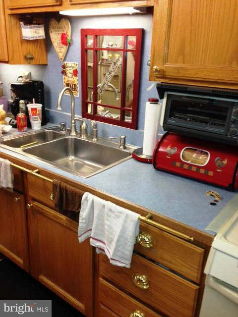 8286 Mission Road Jessup, MD 20794 - Photo 2 of 8 a kitchen with an oven a cabinets and a window