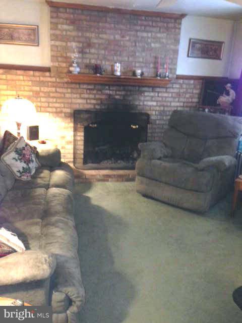 8286 Mission Road Jessup, MD 20794 - Photo 5 of 8 a living room with furniture and a fireplace